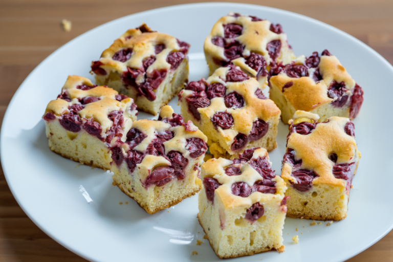 a white plate topped with slices of cake